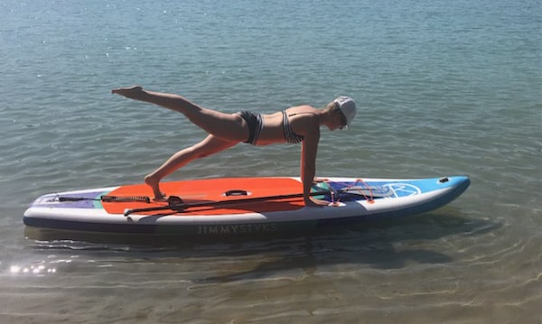 Pilates instructor on a paddle board
